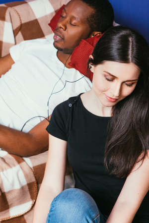 Couple International Young White Black Rest Music Earphones Leisure Relax Togetherness Idyll Pleasure Conceptの写真素材