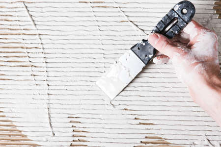 Unrecognizable Builder Repair Spatula Plaster Stucco White Work Smear Spread Free Space Background Conceptの写真素材