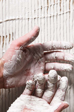 Closeup Worker Hands White Plaster Repair Background Stucco Surface Construction Conceptの写真素材