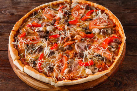 Delicious fresh colorful pizza served on wooden rustic table, top view. Italian restaurant menu photo.の写真素材