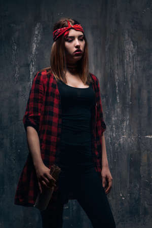 Young woman alcoholic addiction problem,. Tired drunk caucasian girl holding alcohol bottle, she sad and depressed.の写真素材