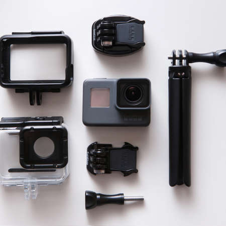 Kharkov, Ukraine - April 13, 2017: GoPro HERO 5 action camera with accessories on white background top view. Compact gadget waterproof, support 4k video and is often used in extreme photographyのeditorial素材
