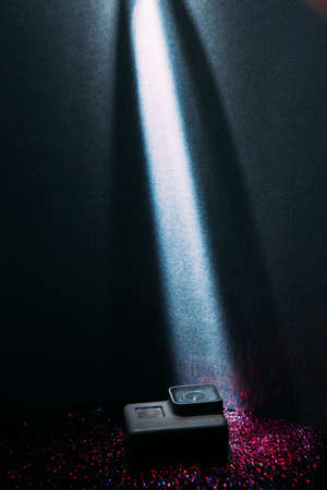 Kharkov, Ukraine - April 13, 2017: GoPro HERO 5 digital action camera in spotlight with sparkles on black. Compact gadget waterproof , support 4k video and is often used in extreme photographyのeditorial素材