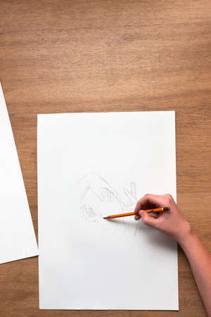 Painter workplace flat lay. Drawing sketches with pencil. Top view of process of creation new picture, art school, unrecognizable artist conceptの写真素材