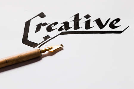 Creative artist workplace. Writer inspiration. Ink handwritten word and pen top view. Painter workshop, art, literature, creativity, handmade drawing conceptの写真素材