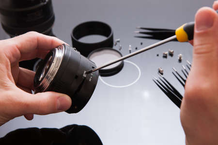 Photo camera lens repair set. Technician engineer check optics alignment and maintenance support of...