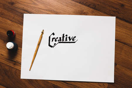 Creative artist workplace. Talent inspiration. Ink handwritten word and pen top view. Painter workshop, art, literature, creativity, handmade drawing conceptの写真素材