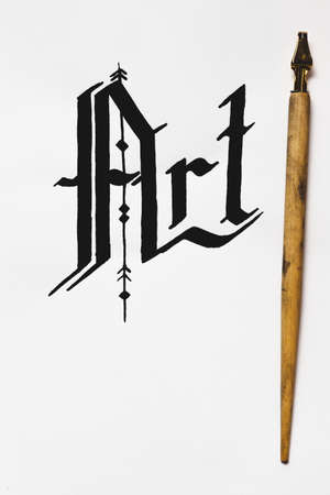 Art calligraphy background top view. Word drawn with ink and feather. Painter workshop, business inspiration, creativity conceptの写真素材