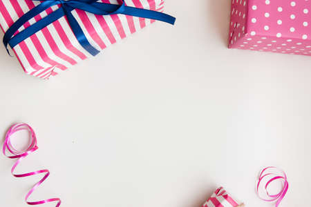 Pink gifts on white. Birthday, anniversary background. Surprise box top viewの写真素材