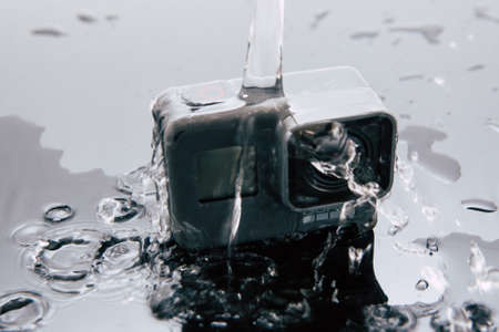 Kharkov, Ukraine - April 6, 2017: GoPro HERO 5 action camera under water flow. Compact gadget waterproof , support 4k video, voice controls and is often used in extreme photographyのeditorial素材
