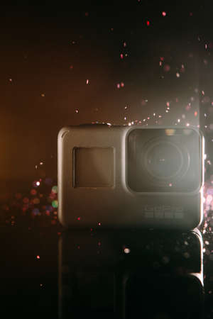 Kharkov, Ukraine - April 13, 2017: GoPro HERO 5 digital action camera with lens flare closeup. Compact gadget waterproof , support 4k video, voice controls and is often used in extreme photographyのeditorial素材