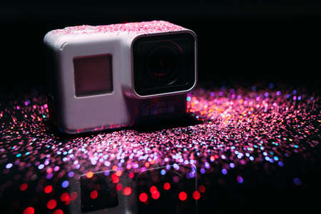 Kharkov, Ukraine - April 13, 2017: GoPro HERO 5 digital action camera in spotlight in sparkles on black. Compact gadget waterproof , support 4k video and is often used in extreme photographyのeditorial素材