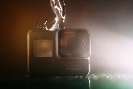 Kharkov, Ukraine - April 13, 2017: GoPro HERO 5 digital action camera with water with lensflare on black. Compact gadget waterproof , support 4k video and is often used in extreme photographyのeditorial素材