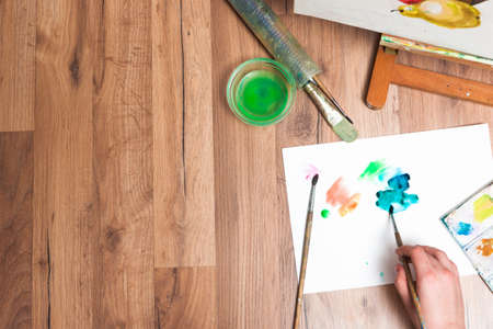 Painter workplace. Real watercolor work top view. Drawing lessons, art school, young artist, creativity conceptの写真素材