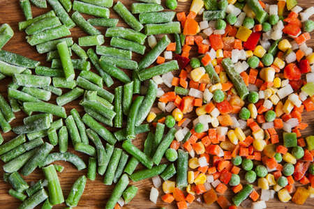 Frozen asparagus and dietary mix for cooking. Vegetables assortment on cutting board, salad cooking backgroundの写真素材