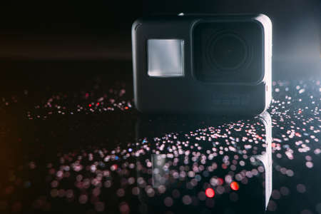 Kharkov, Ukraine - April 13, 2017: GoPro HERO 5 digital action camera with sparkles on black. Compact gadget waterproof , support 4k video, voice controls and is often used in extreme photographyのeditorial素材