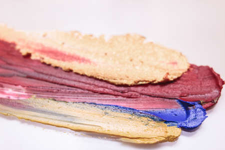 Lipstick colorful selective focus white backdrop. Cosmetics background, beautiful style. Creative process, makeup conceptの写真素材