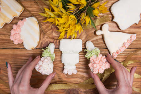 Decorated colorful gingerbread by girl, tasty food, Beautiful present, yellow tulips, love gifts. Valentines Day background, cooking conceptの写真素材