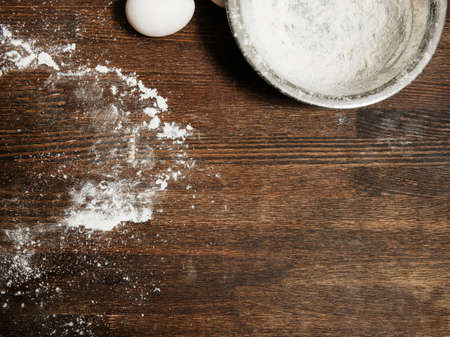 Dirty cooking table with flour and bowl, eggs food concept, top view copy spaceの写真素材
