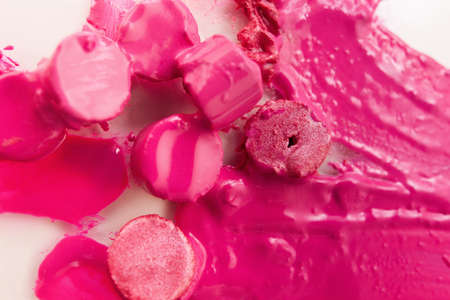 Pink lipstick chopped and melted on background. Cosmetics commercial, beautiful style closeup. Glamorous magazine, creative advertising, beauty conceptの写真素材