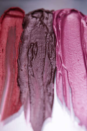 Colorful lipstick swatch on gray background. Creative advertising, cosmetics commercial. Glamorous magazine, selective focus, beauty conceptの写真素材