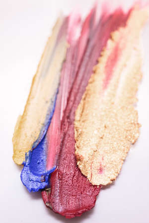 Lipstick mix in selective focus on white backdrop. Professional cosmetics background, beautiful...