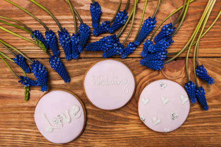 Wedding gingerbread and muscari on wooden table. Love background, beautiful morning. Tasty dessert, food conceptの写真素材