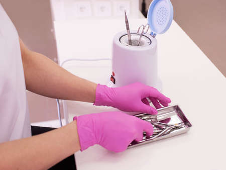 Disinfection in manicure. Manicurist disinfect tools. Salon care for beauty and health.の写真素材