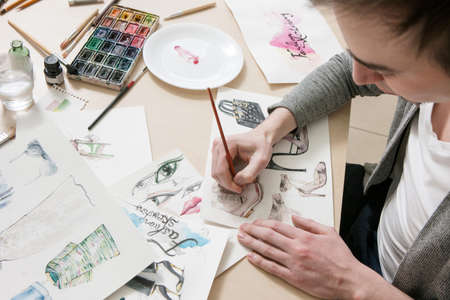 Design of new clothes and shoes. Designer immersed in his workの写真素材