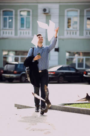 Confident and happy adult man took vacation. Joyful and free businessman on streetの写真素材
