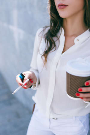 Bad habits in young woman life. Unrecognizable business lady at coffee break, difficult work dayの写真素材