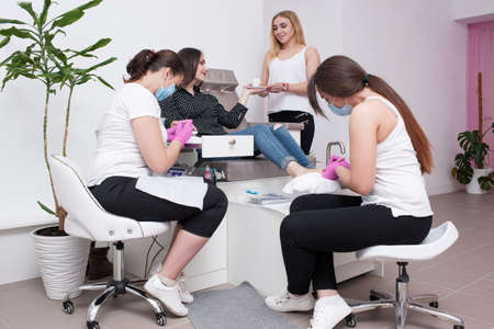 Conjunction gel polish manicure and pedicure. Professional body care service for beauty and health in salon.の写真素材