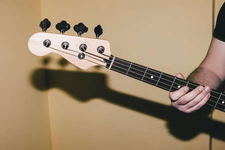 Bass guitar riff closeup. Music background. Unrecognizable guitarist playing string instrument. Band...