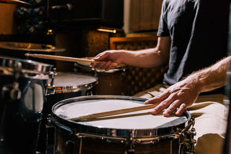 Drummer with drums closeup. Recording studio, professional music process, live concert, hobby for maleの写真素材