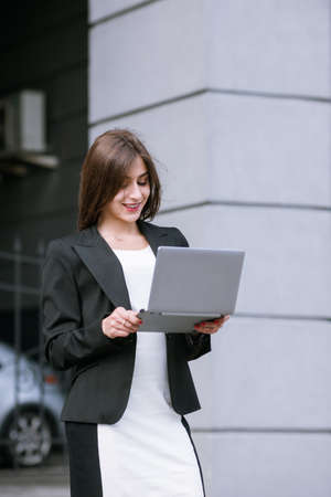 Communication in social media. Happy young woman. Girl with laptop, love relationships on internetの写真素材