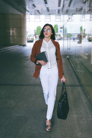 City pedestrian. Stylish business woman. Successful young female going on work, beauty concept