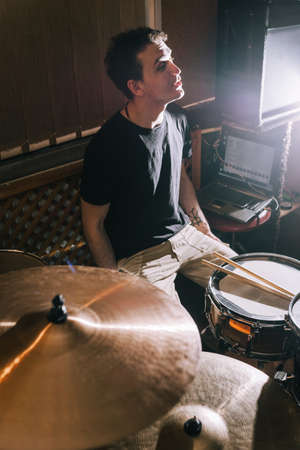 Musical rehearsal. Creating new music on drums, drummer in recording studio, percussion instruments