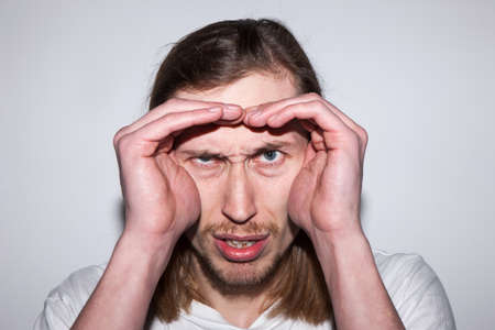 Uncertain male searching for information. Young man looking for his place in world, guy seeking for future prospects in lifeの写真素材