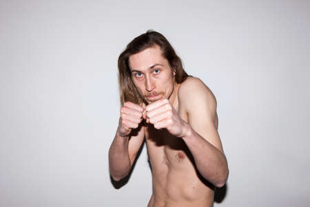 Angry fighting man. Adult male boxer. Sorting out relationships, furious gangster guy battling with someone, aggression conceptの写真素材