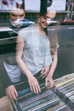 Family couple. Common hobby in old music. Happy choosing birthday present, nice pastime togetherの写真素材