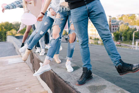 Friends company. Party celebration outside. Unrecognizable group of people, funny pastime togetherの写真素材