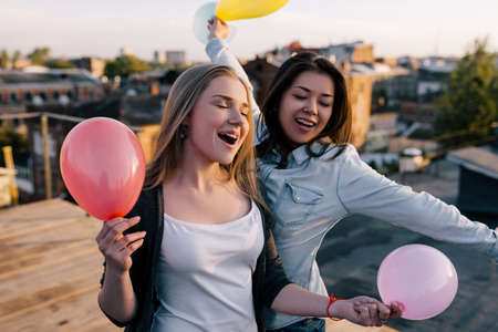 Creative friends birthday party outdoors. Female friendship, happy celebrationの写真素材