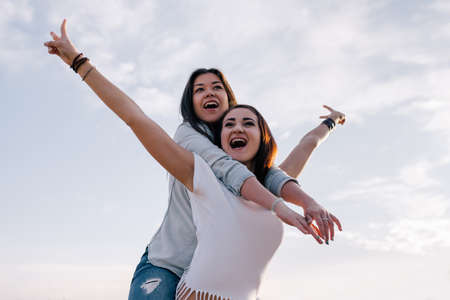 Victory in female friendship. Happy girls. Women taking selfie, modern social communicationの写真素材