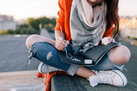 Illustrator beginner. Unknown painter outdoors. Creative artwork, unrecognizable femaleの写真素材