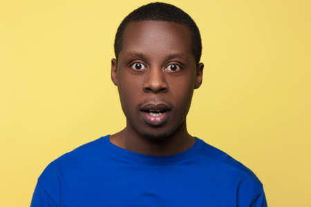Astonished African American. Surprise emotion. Shocking news for black man, handsome male portrait, facial expression conceptの写真素材
