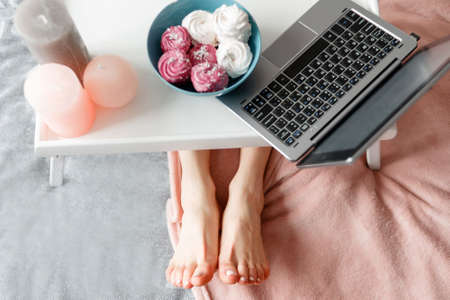 Unrecognizable woman working in the morning. Early breakfast combining with social life, chatting...