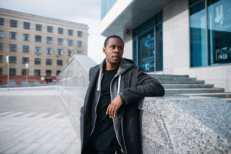 Stylish black hipster. Street fashion. Thoughtful looking African American man in selective focus,...