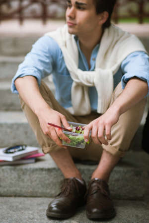 Healthy food diet outdoors. Thoughtful male. Lunch break with salad, stylish young man, nutrition...