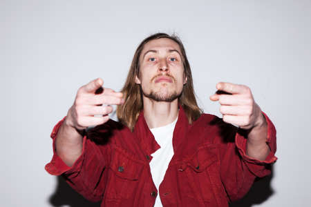 Aggressive and impudent young male. Man accusing someone, bad relationships, aggression conceptの写真素材