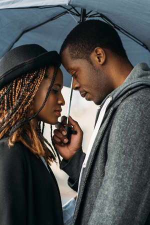 Romantic date. Tender black couple. African American cute relationship, beautiful young people on rainy day, stylish conceptの写真素材